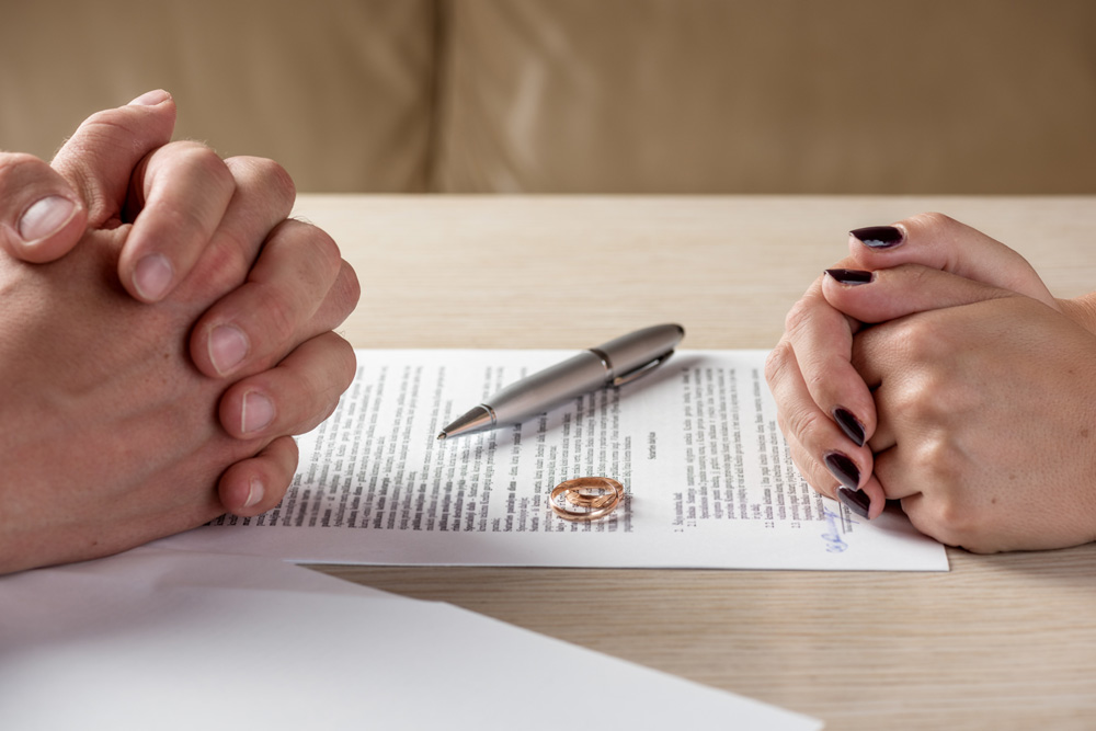 Wife and husband signing divorce documents